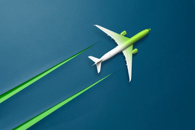 a green airplane flying